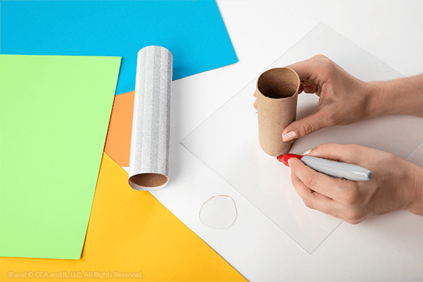 Tracing paper towel tube on paper