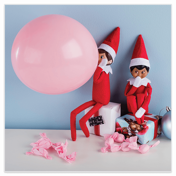 Scout elf blowing up pink balloon