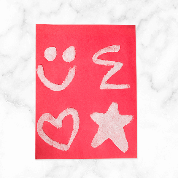 Invisible ink craft with red paper and dried salt