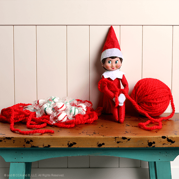 Elf tied up in yarn and candy