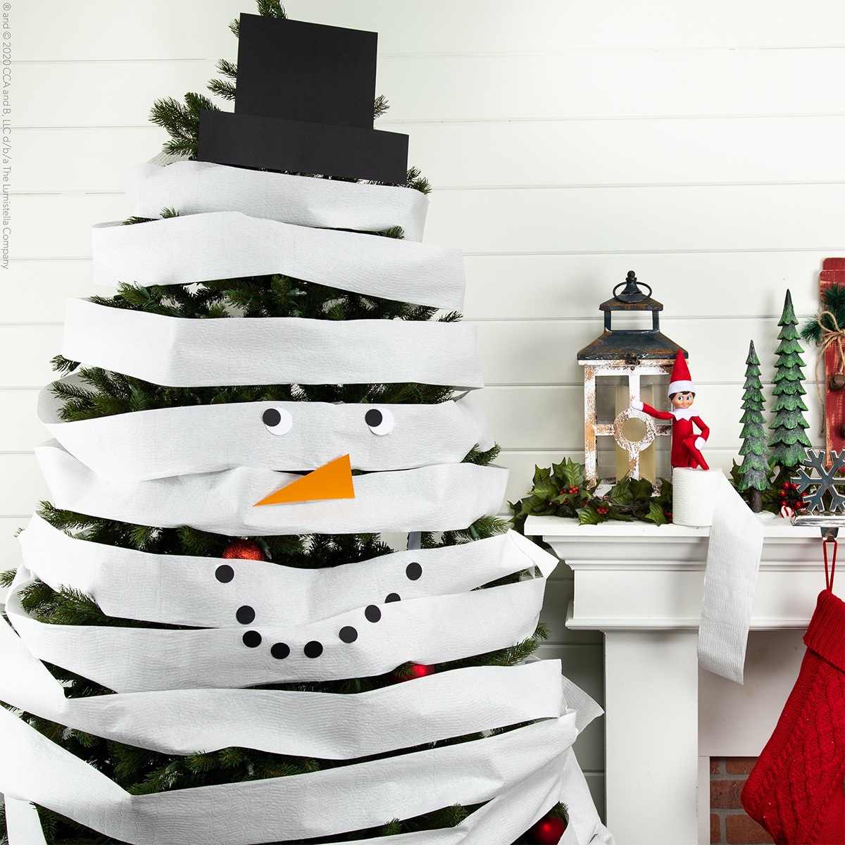 Christmas tree wrapped in toilet paper to be a snowman