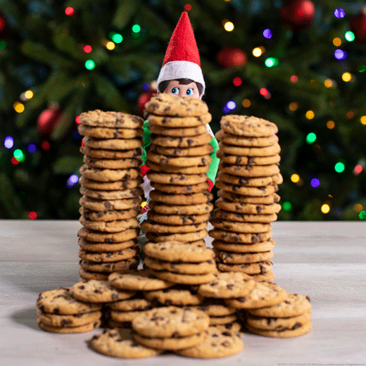 Elf with Christmas cookie PJs and stacks of cookies