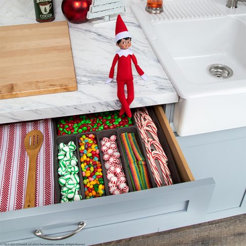 Elf with cutlery drawer full of candy