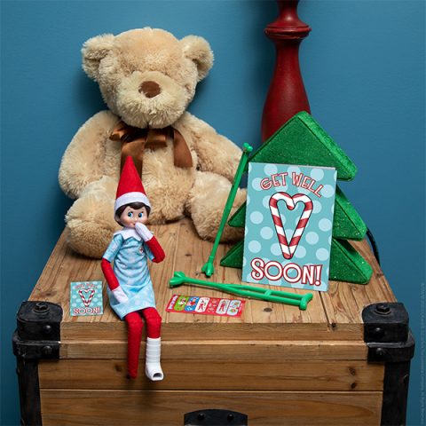 Elf in foot cast and hospital gown with 'get well soon' printable. 