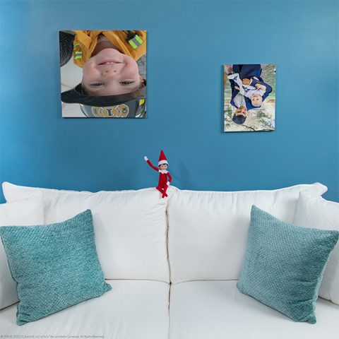 Elf sitting with flipped photographs