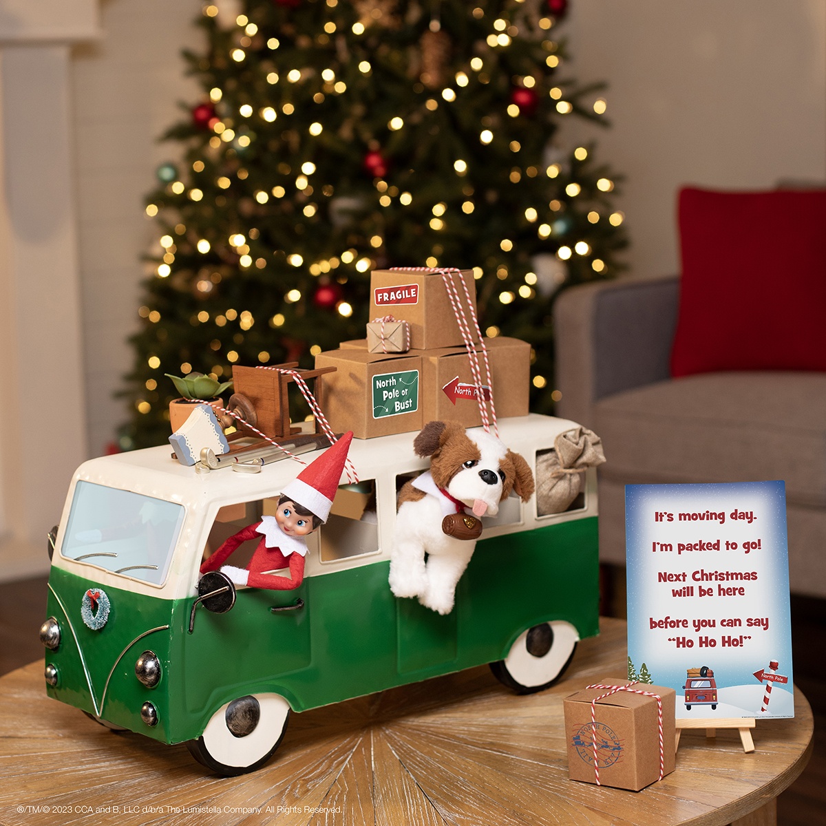 The Elf on the Shelf and Elf Pets® Saint Bernard in small van with boxes like they’re moving back to the North Pole.