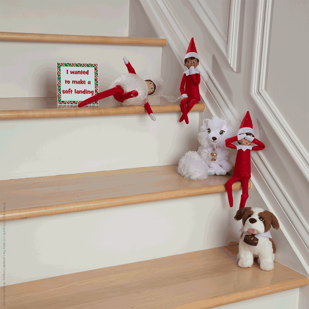 The Elf on the Shelf wrapped in bubble wrap and sitting with friends on stairs