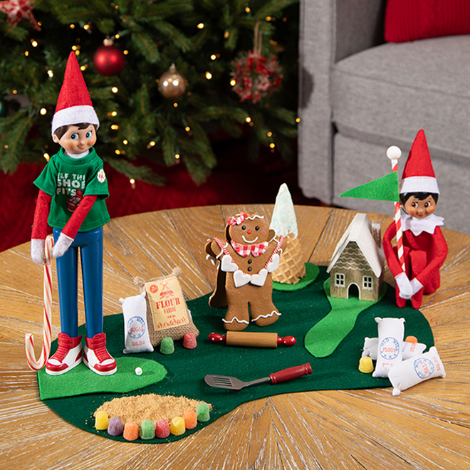 The Elf on the Shelf and friend playing golf with a candy cane golf club
