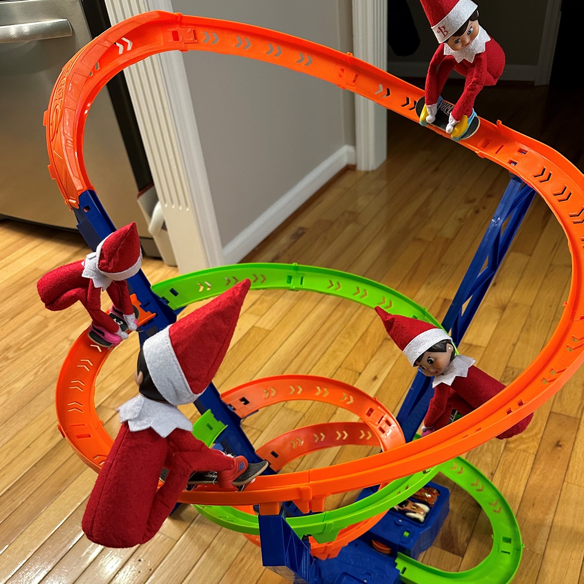 Scout Elves skateboarding down a play car ramp