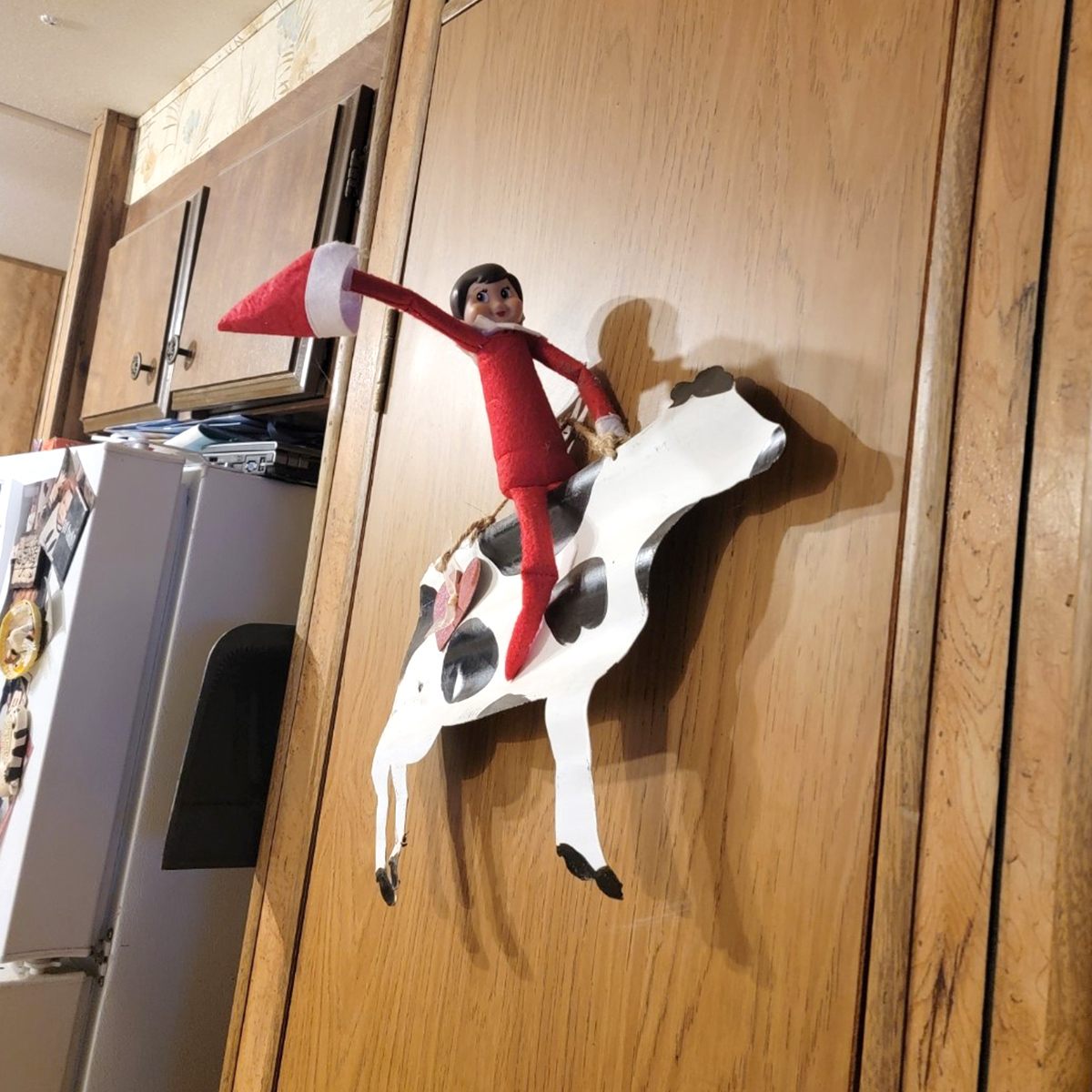 A Scout Elf riding on a wooden cow