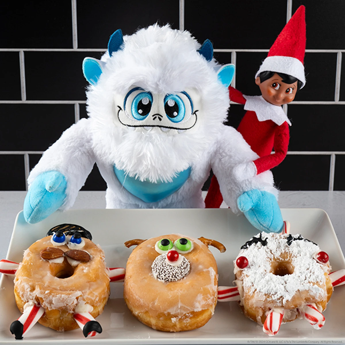 SnoBiggie Yeti Lil Grunt and Scout Elf with some fun, decorated donuts.