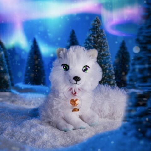 The Elf Pets arctic fox sits in a snowy North Pole scene as the norther lights glow in the background