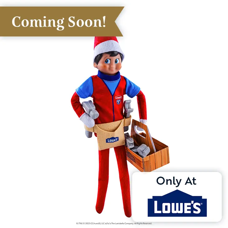 Scout Elf boy with light skin and blue eyes wearing the Polar Props™ Fix-It Fun Prop Set. He has his right hand on his hip and the toolbox carried by his left hand. At the top left there is a Coming Soon banner, and on the bottom right is a graphic that says Only at Lowe's.