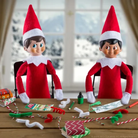 Two Scout Elves at a table making crafts