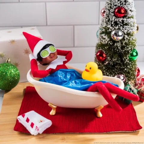 The Elf on the Shelf Scout Elf girl relaxes in a tiny bathtub