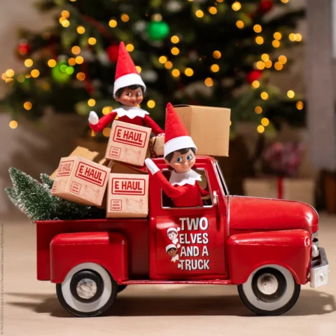 Two Scout Elves drive a truck full of moving boxes