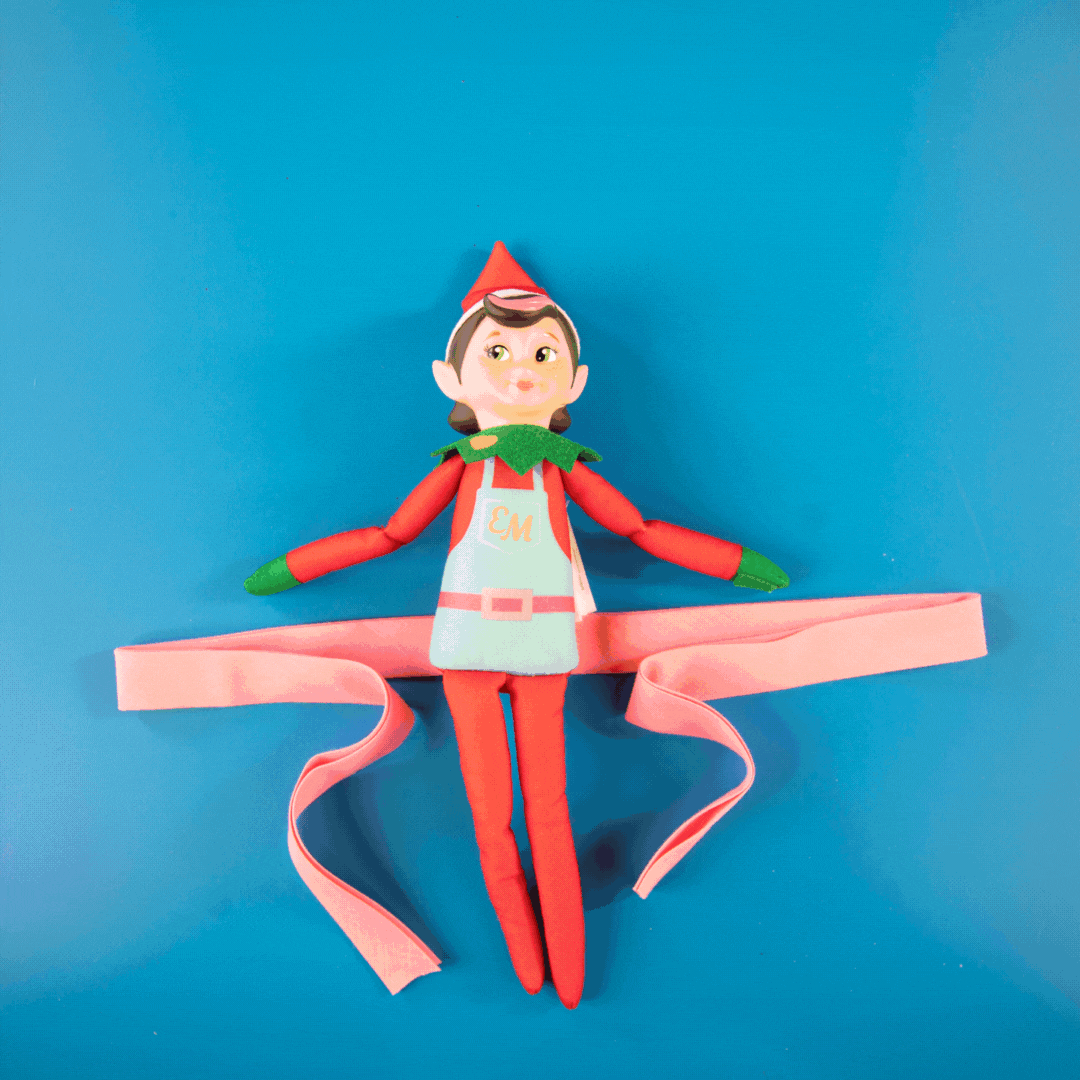 Series of images showing Elf Mates girl being tied with ribbon to work as a bag charm