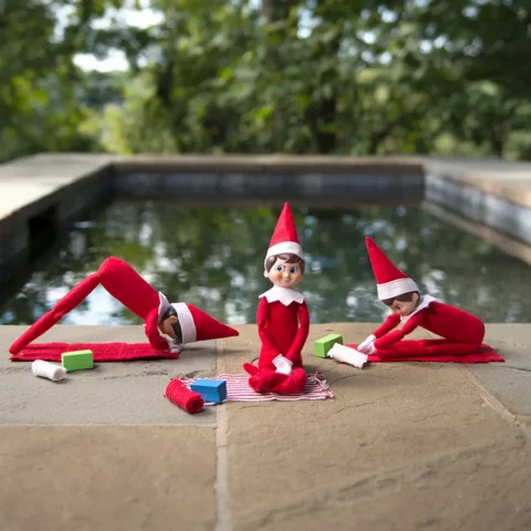 Three Scout Elves practice yoga poses