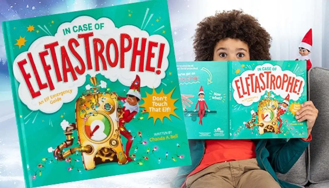 In Case of Elftastrophe: An Emergency Guide book is featured on the left-hand side, while a lifestyle image of a young boy is on the right-hand side. He is pictured seated on a gray sofe with the book covering his nose and mouth, but the top of his head is exposed. He has a surprised look in his eyes. Also pictured behind him is a Scout Elf.