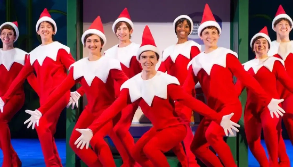 A cast of actors dressed as Scout Elves, performing in a musical about The Elf on the Shelf in a partnership with Mills
