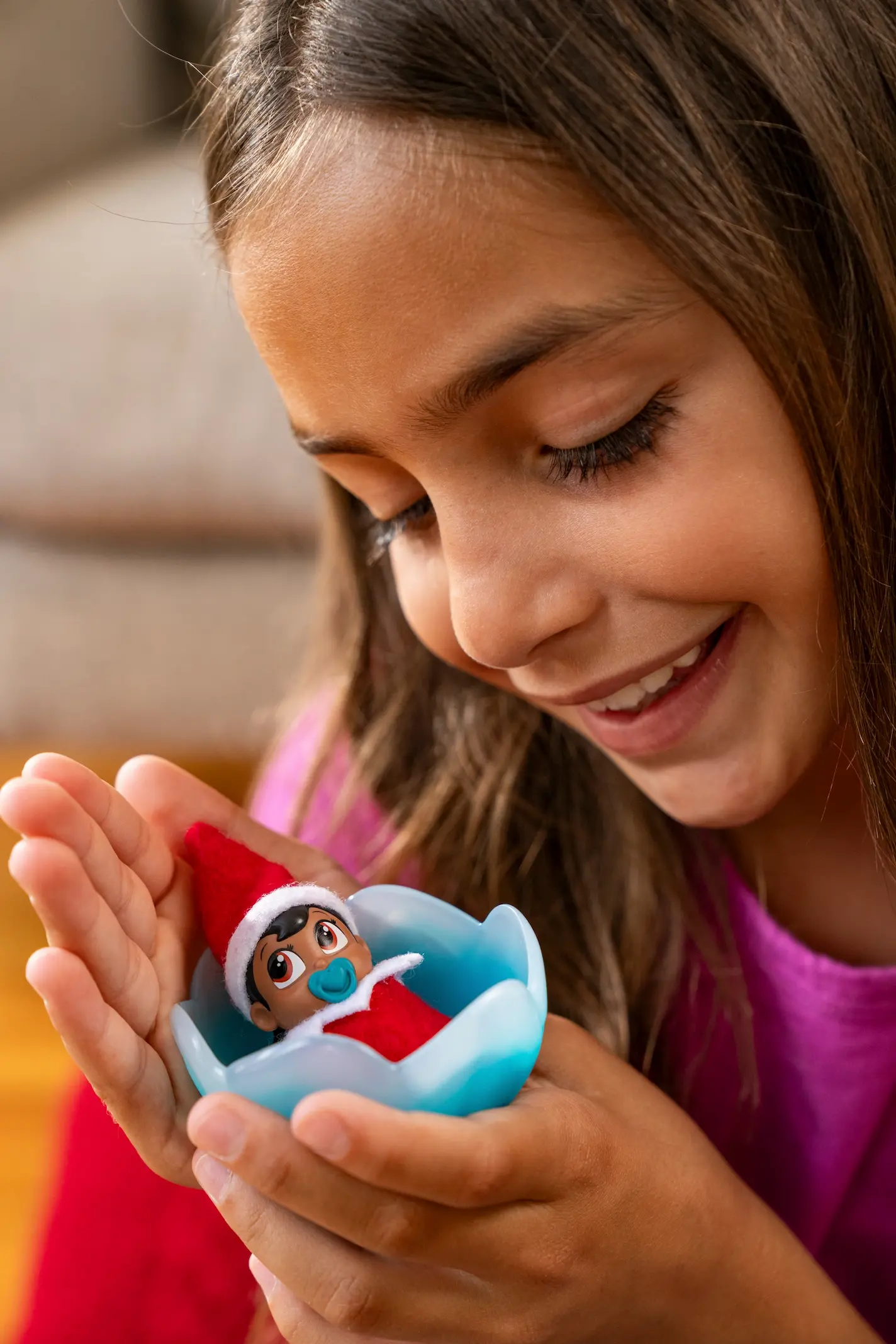 A Girl plays with a Frost Pips elf baby