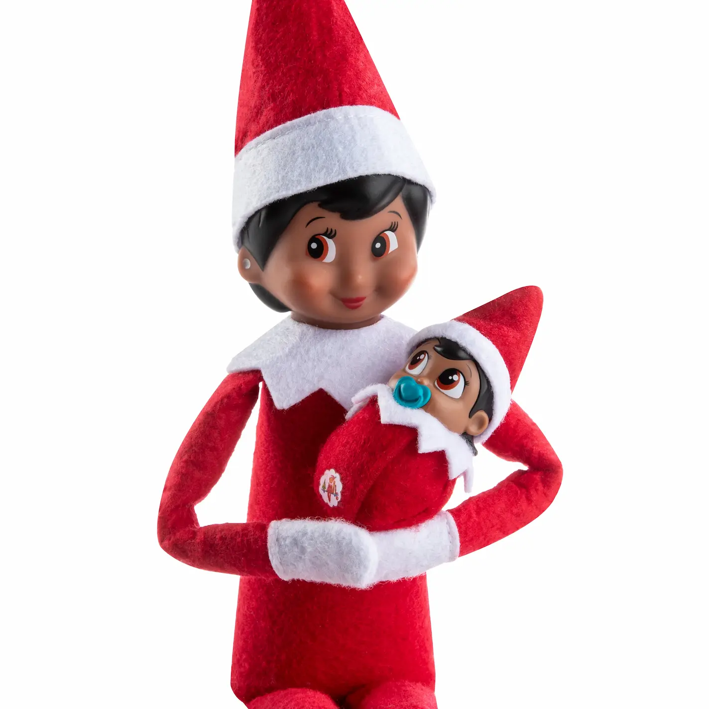 The Elf on the Shelf Scout Elf cradles a Frost Pips in her arms