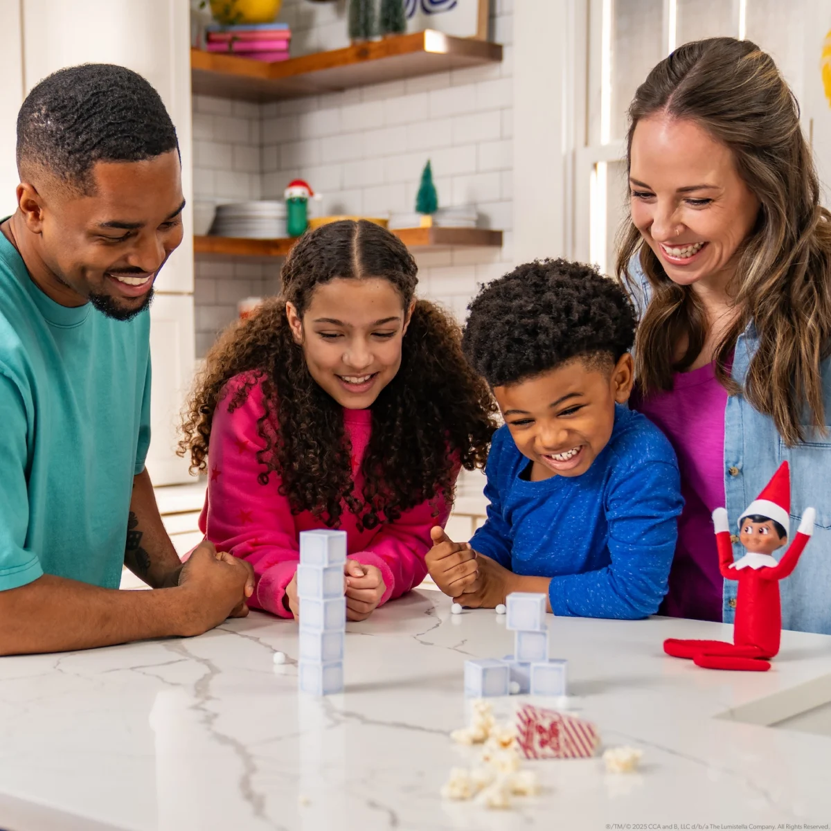 A family plays a game from The Elf on the Shelf Fun & Games Elf Ideas Kit