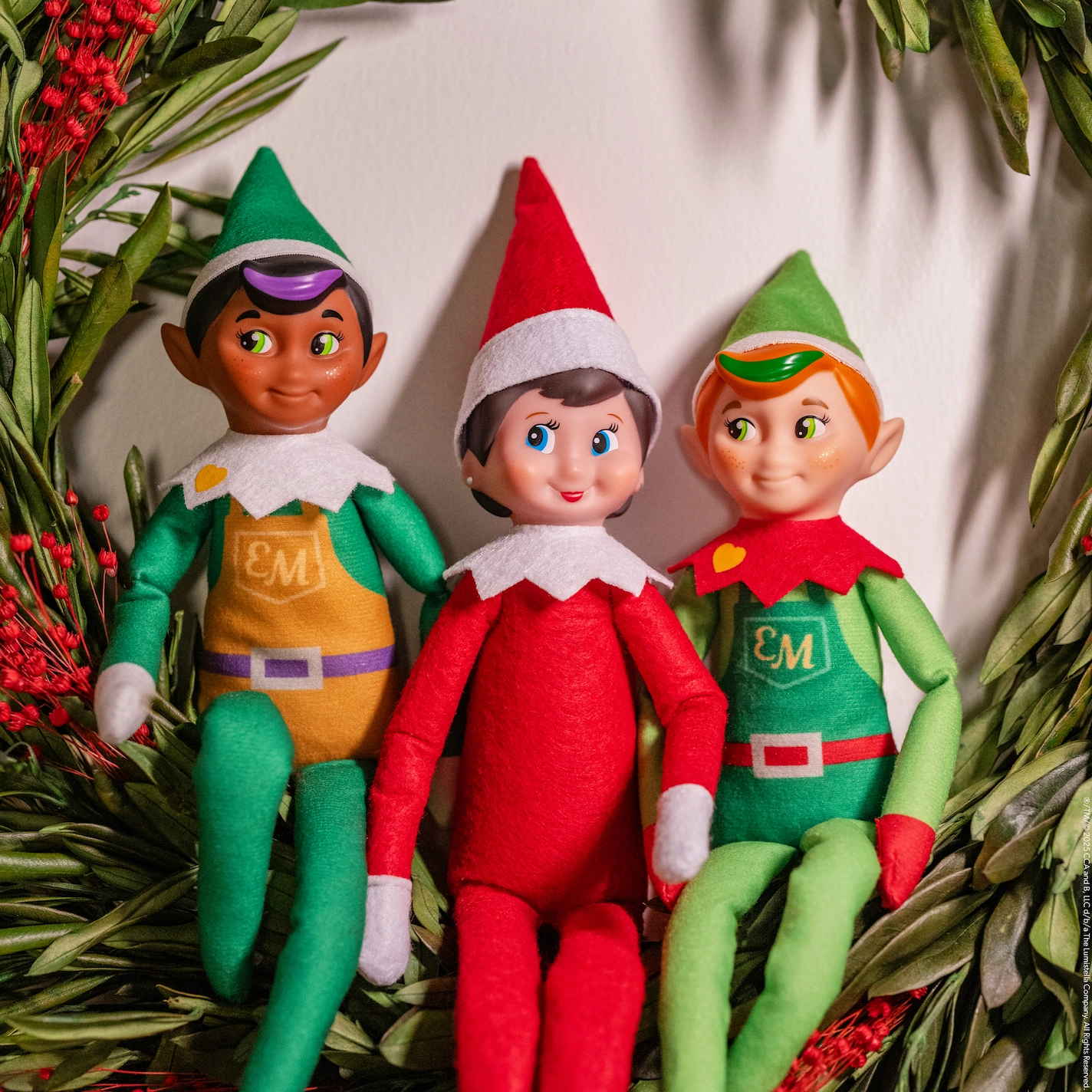 The Elf on the Shelf sits with two Elf Mates with a message that the Elf on the Shelf is leaving but their friends can stay behind