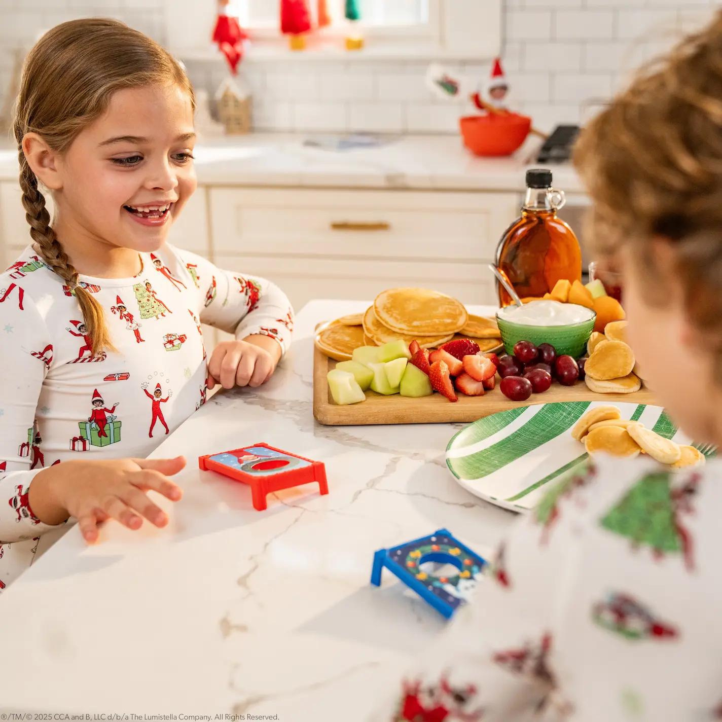 Two children play a game of mini cornhole