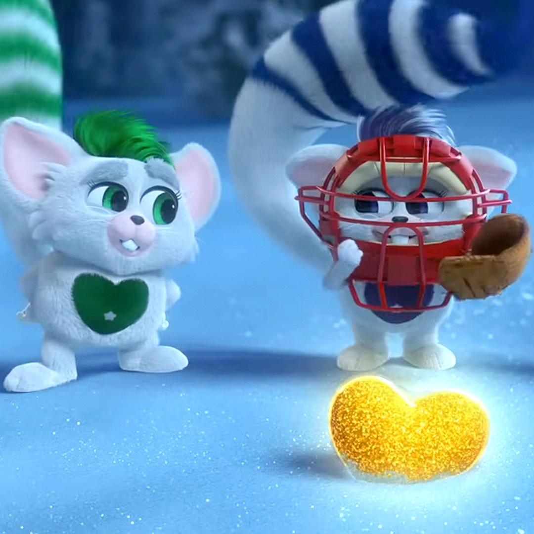 A still of a pair of Bogies from the Sleigh Bell Mishap: Bogies to the Rescue official video on YouTube. One Bogie, Zaspar, is sporting a baseball catcher's mask and mitt. They are in the snowscape of the North Pole. In front of them is a glowing, glittery yellow heart. The green Bogie looks onto the other Bogie with a quizzical look while Zaspar returns a sheepish look after a failed attempt.