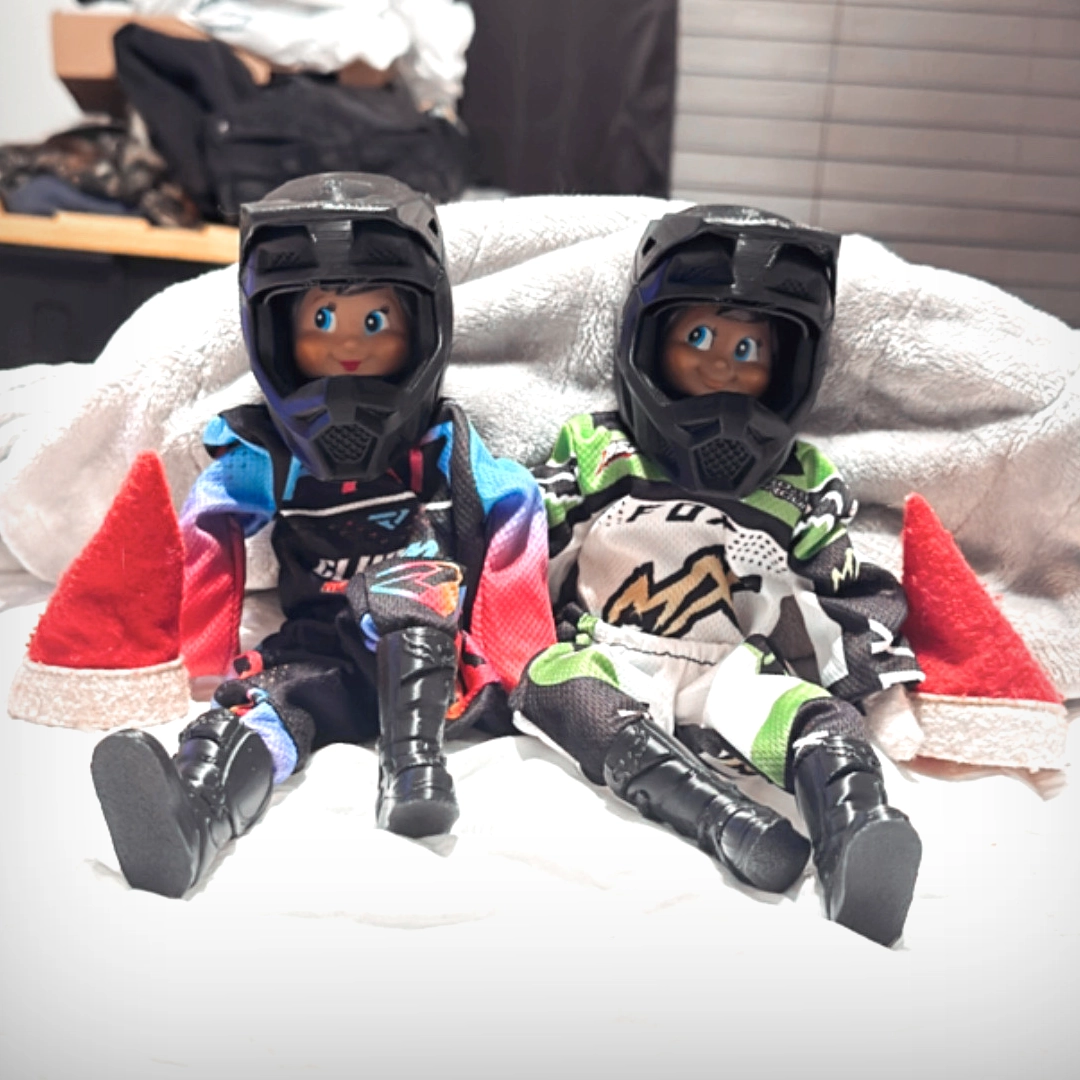 A pair of Scout Elves are decked out in full motocross gear, with mini helmets, suits and boots.