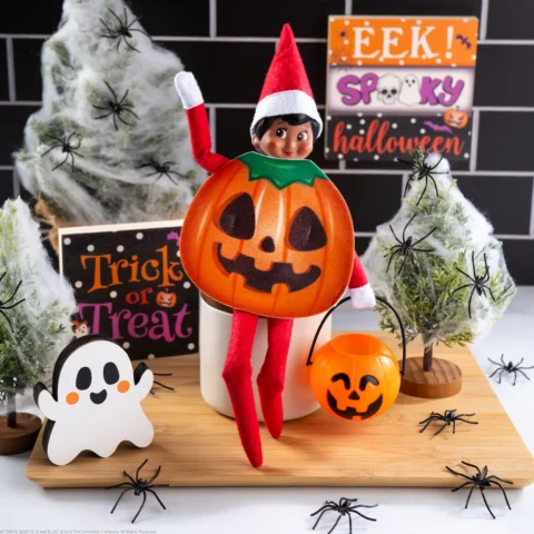 The Elf on the Shelf wearing a jack o'lantern costume