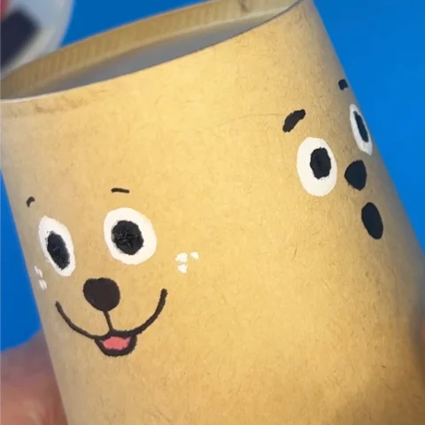 Reindeer faces being drawn on a paper cup