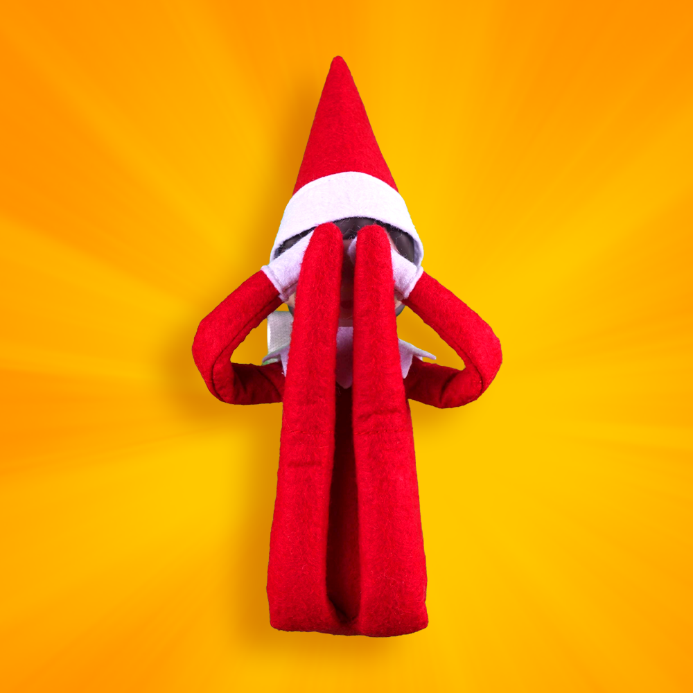 Brown eyed boy Scout Elf covers eyes with legs folded up in front of his face, as if doing a jump that folds him in half