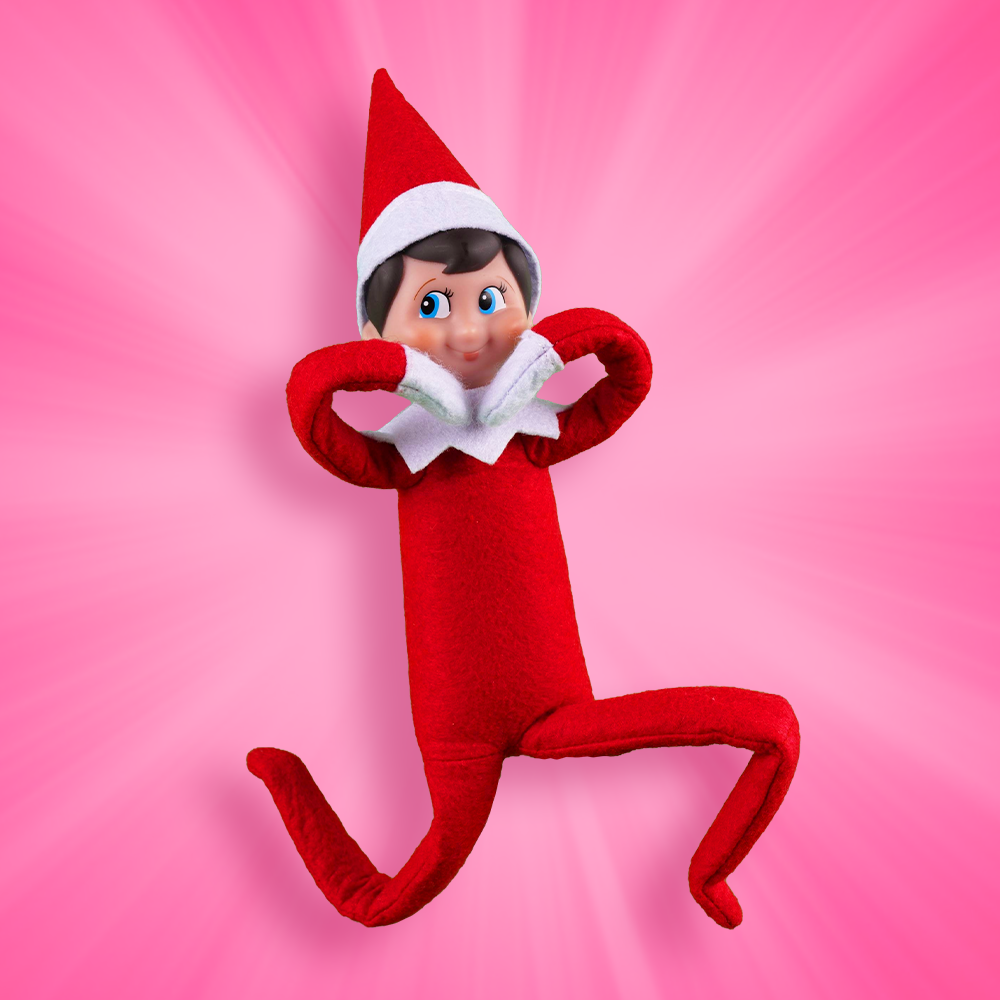 A Scout Elf in front of a pink background makes a heart shape with his arms.