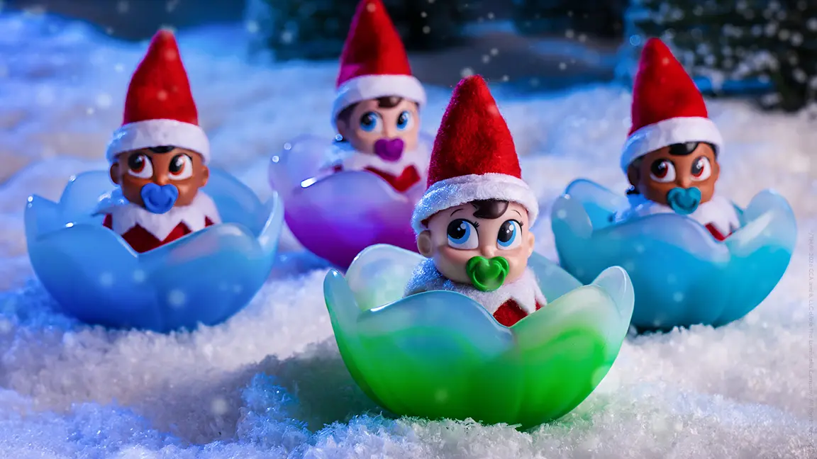 The 4 Frost Pips sitting in their flowers in the North Pole snow