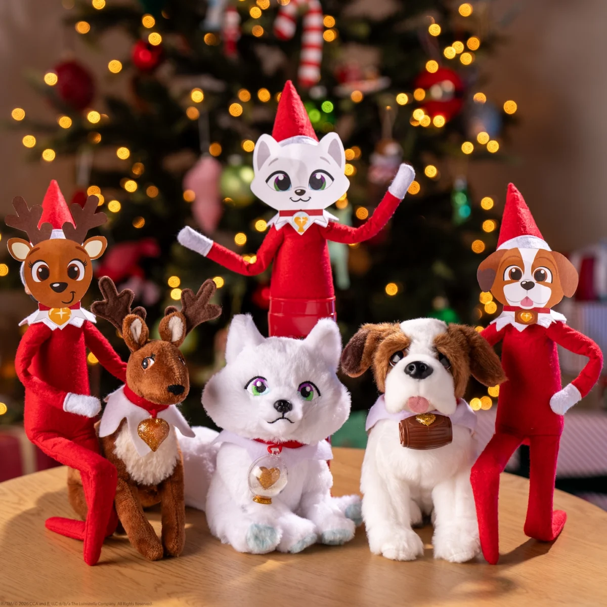 Scout Elves playfully wear Elf Pets face masks and pose beside the Elf Pets