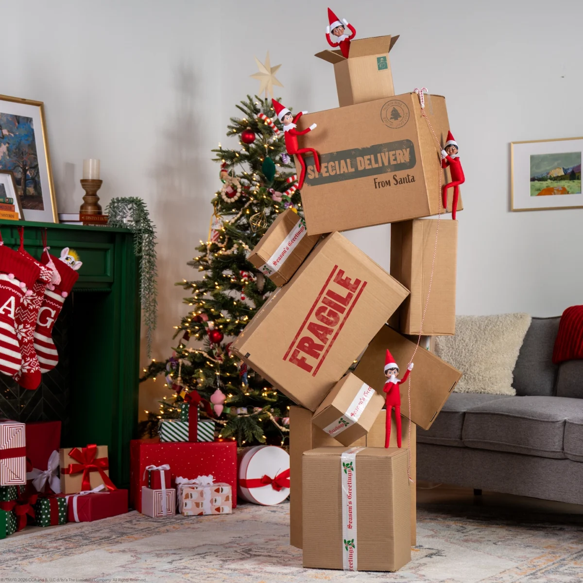 Scout Elves climb up moving boxes marked Fragile that are precariously stacked