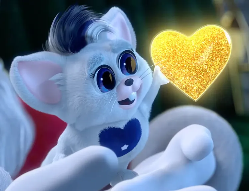 Blue and white bogie sitting in Santa's hands reaching for a gold heart