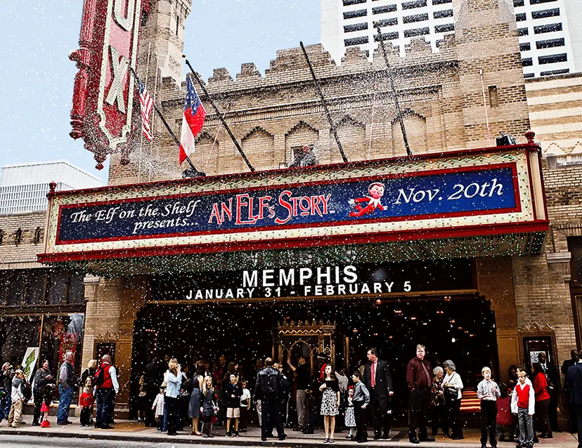 Outside of the Fox Theatre in Atlanta with its marquee featuring the An Elf's Story