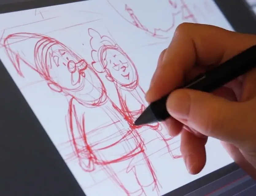 Hand drawing a stylized Santa Claus on a graphics tablet