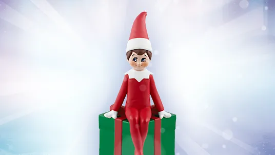 A The Elf on the Shelf Tonies. The toy is a Scout Elf sitting on a green and red Christmas gift.