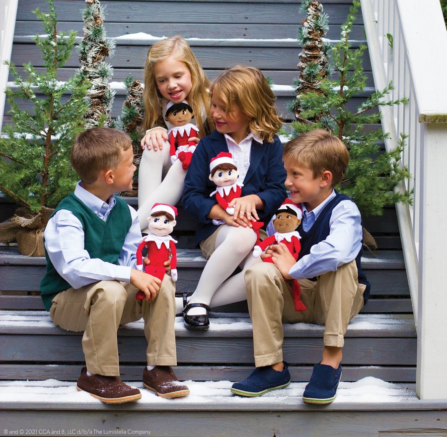 four kids sitting on steps with Plush elves