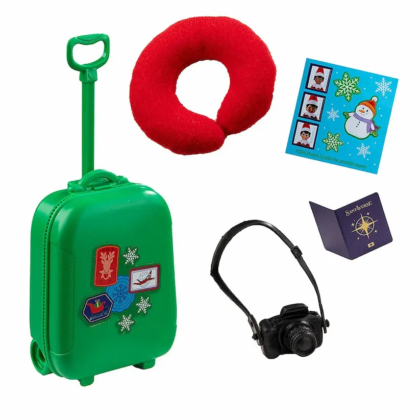 An elf-sized neck pillow, rolling suitcase, camera, passport, and a suitcase sticker sheet