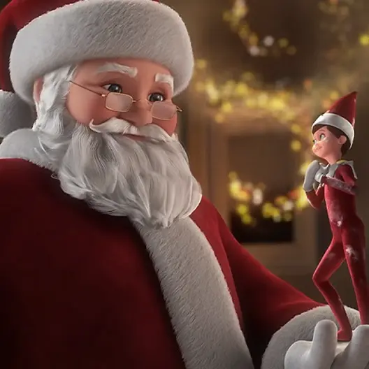 Santa Claus in his red and white suit holding his left hand up with a boy Scout Elf standing in his palm. Santa Claus and the Scout Elf are smiling and looking at each other. The Scout Elf has his hands crossed across his heart. In the background are trails of gold sparkles.
