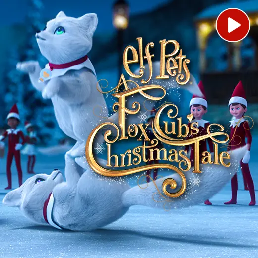 Two Elf Pets Fox Cubs playing in the snow in the North Pole City Center. Behind them are a bunch of Scout Elves watching. The Elf Pets Fox Cub's Christmas Tale logo is in the center. In the top right corner is a video icon.