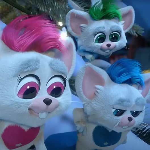 Three Bogies standing in a group on a branch of a snow-covered Christmas tree. One Bogie is pink and white, one is blue and white, and one is green and white. They are all looking down at the ground.
