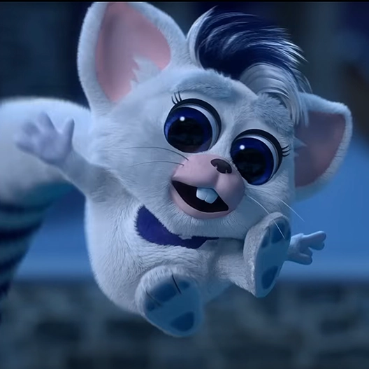 A dark blue and white Bogie gleefully jumping up in the air. Behind him is a snow-covered stone retaining wall.