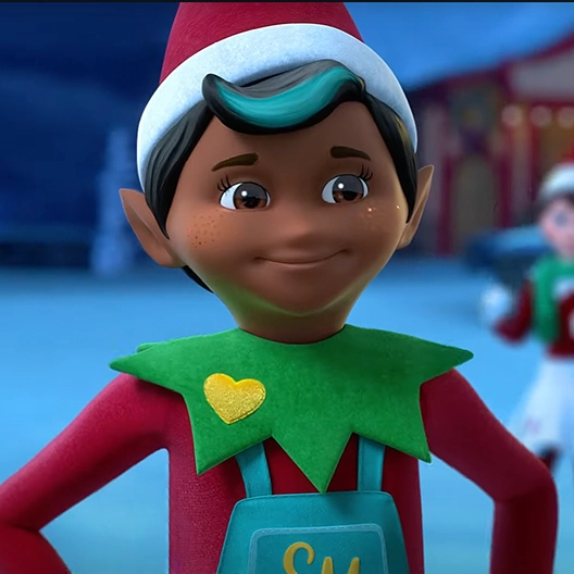 A smiling chef from the chest up with his hands on his hip. In the background is Santa's North Pole City Center and a girl Scout Elf with a green scarf.