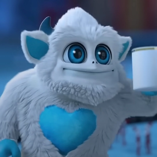 Little Grunt from the waist up smiling and holding up a gold and white mug of hot cocoa with his left hand.